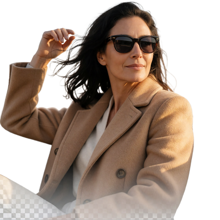 Confident woman with windswept hair in a camel driving coat, illustrating spontaneity in cougar dating