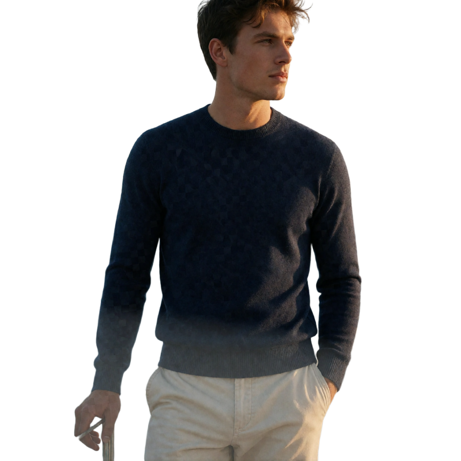 Young man in a navy knit standing relaxed on a boat deck with sea breeze moving his hair, representing travel access in toy boy dating